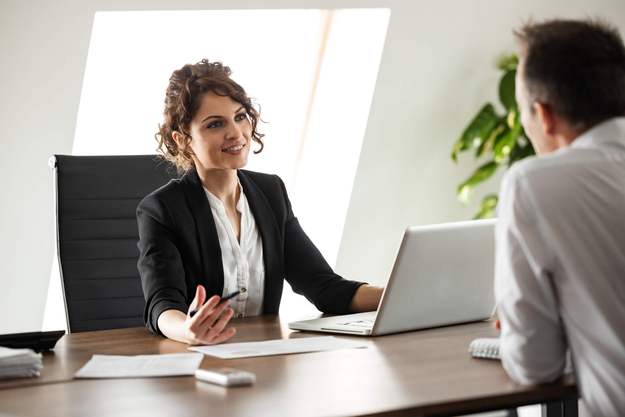 smiling-consultant-talking-to-a-client-on-a-business-meeting-portrait-.jpg